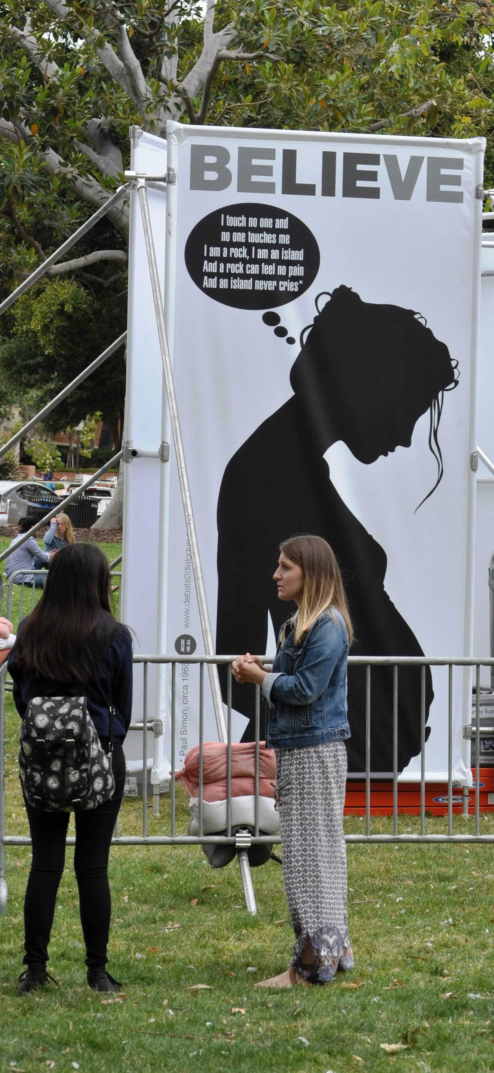 Meredith and another UCLA student talk in front of JFA's new Stop and Think Exhibit in May 2016.