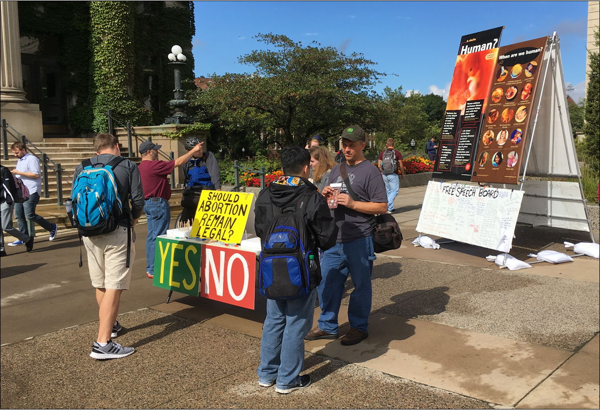 JFA Chief Operations Officer Paul Kulas (right, with brochure) at the UMN outreach in October