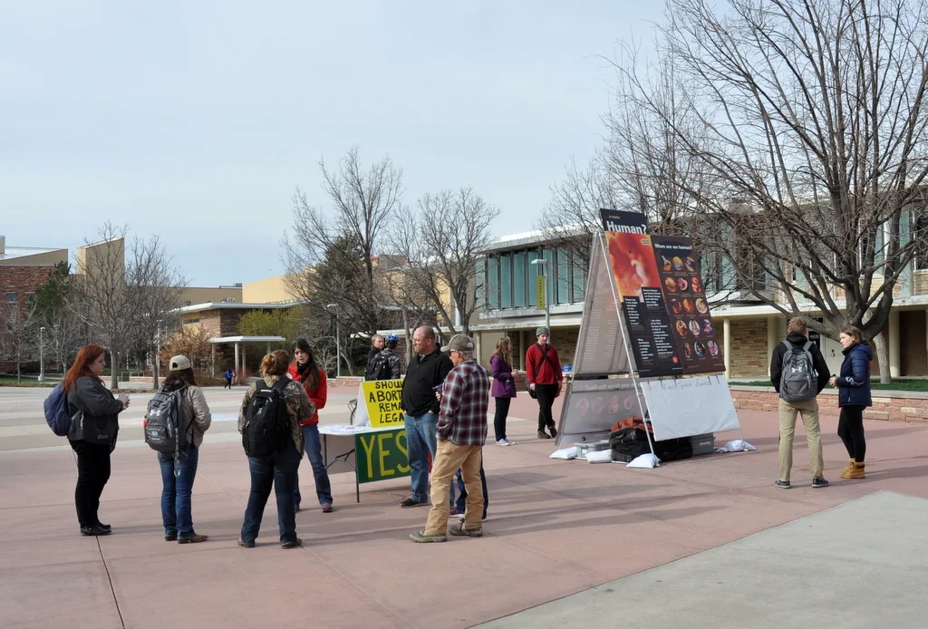 Four simultaneous conversations are shown taking place during JFA's outreach event at Colorado State University (CSU) in April 2018.