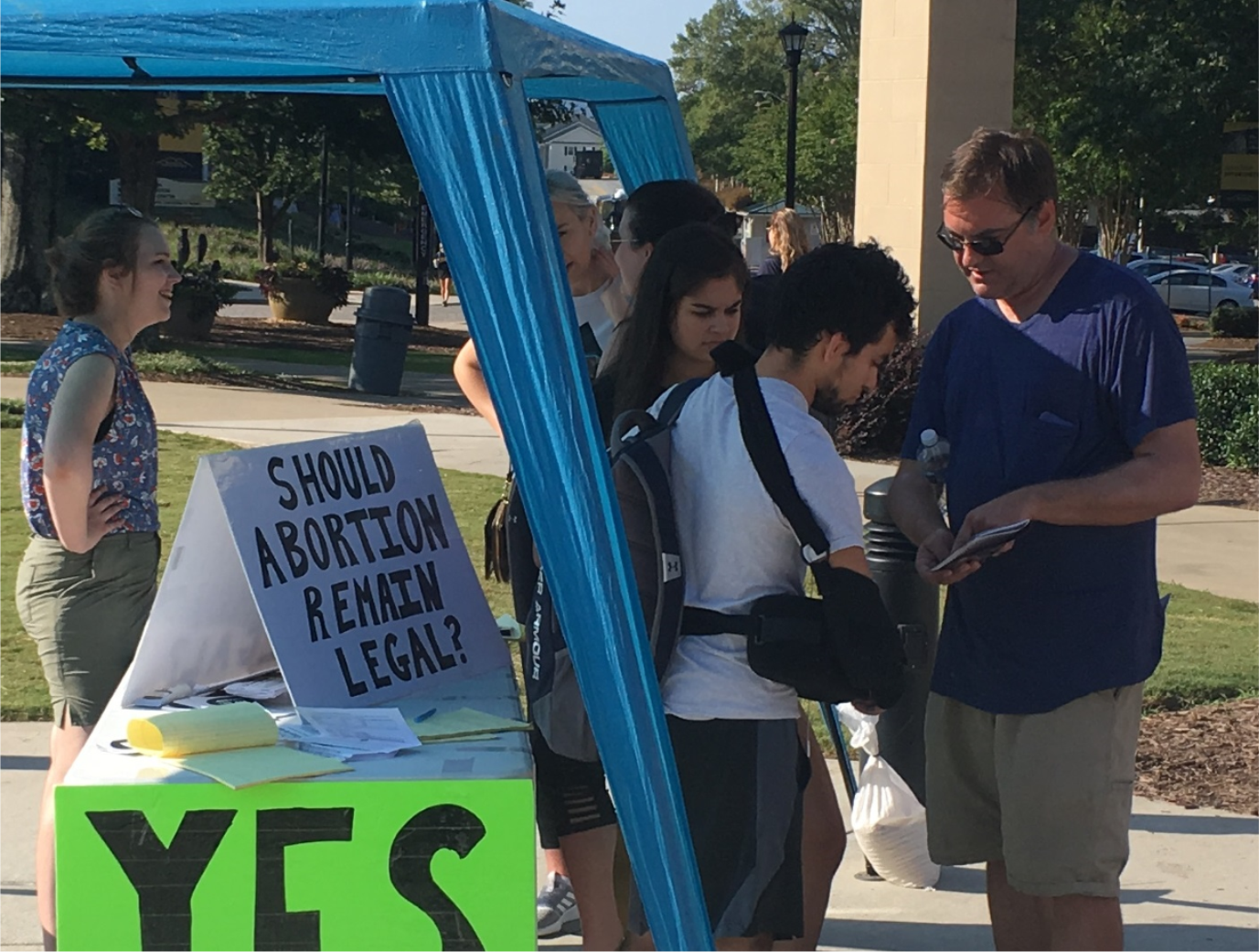 Grace (left) and Jeremy (right) interact with students near our poll table at Kennesaw State University (KSU).