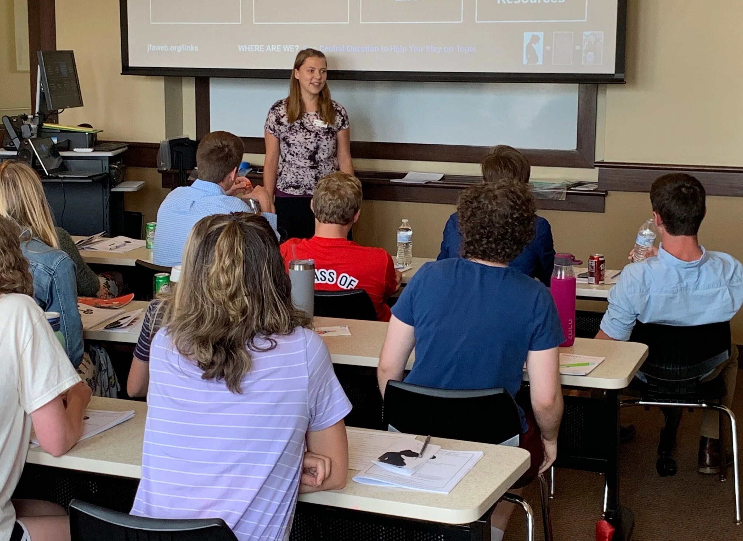 Sunday (Benedictine College): Kaitlyn Donihue speaks to 28 students (not all pictured) who attended the Sunday seminar. Ten returned on Monday night for advanced dialogue training.