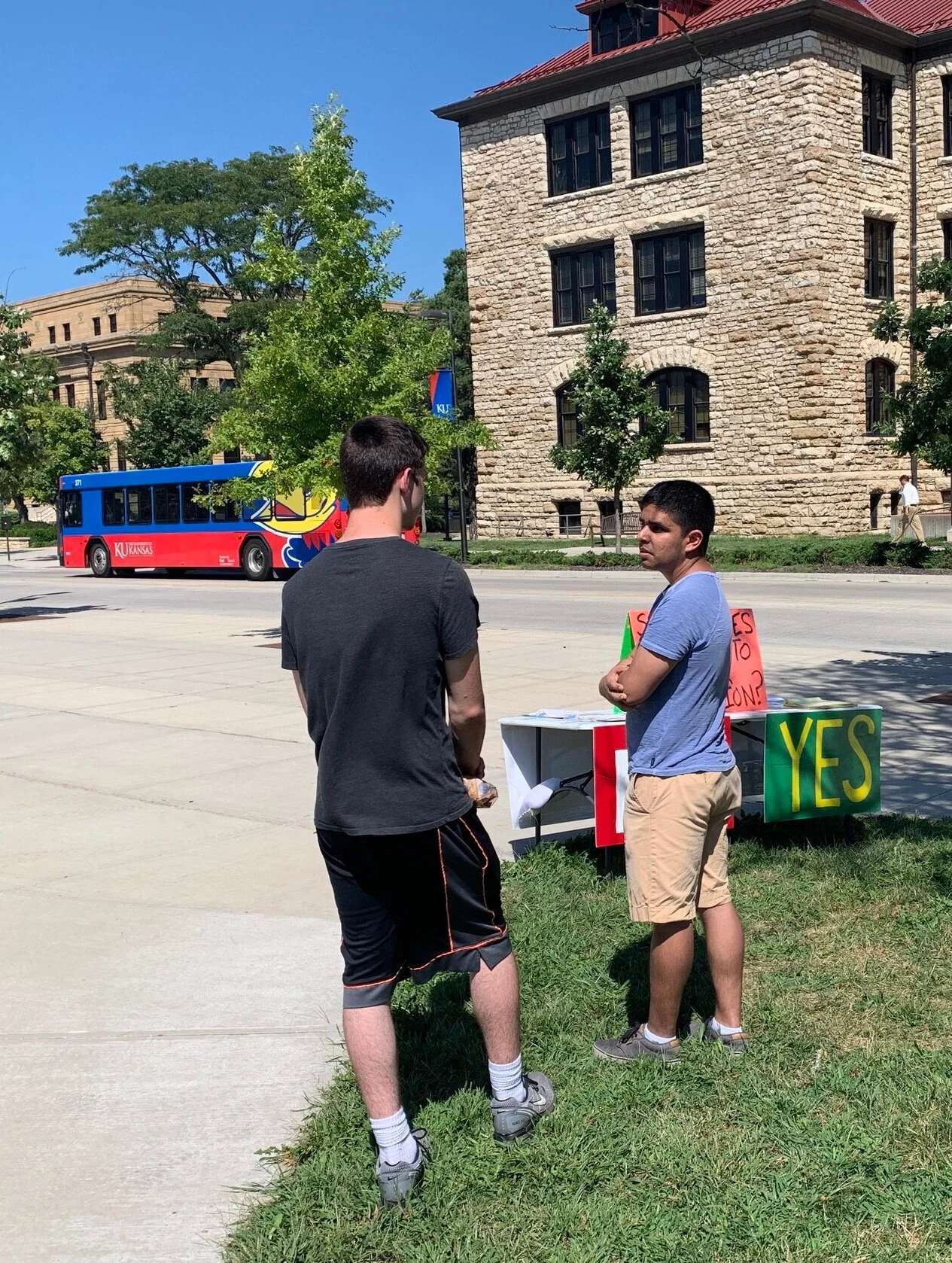 Wednesday (KU): Eric (right), president of the Wichita chapter of Life Runners , talks with a KU student.