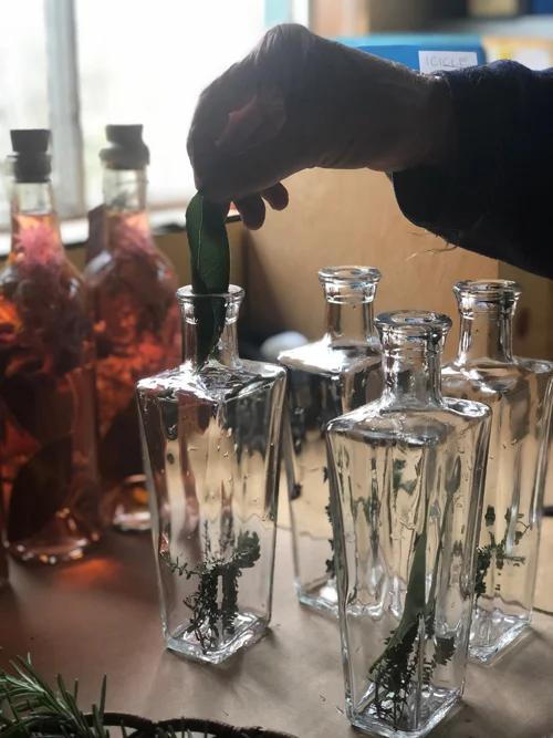 Suzanne at work in her apothecary, preparing botanical infused vinegars.