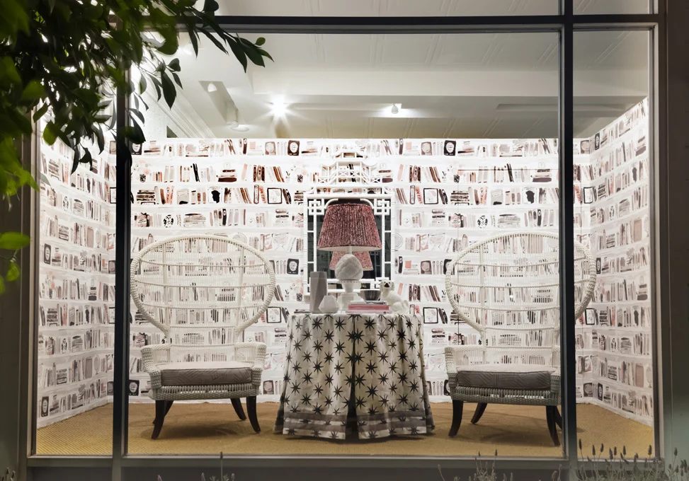 Massucco Warner Miller’s pattern filled window + wicker chairs with Miramar fabric-covered cushions.