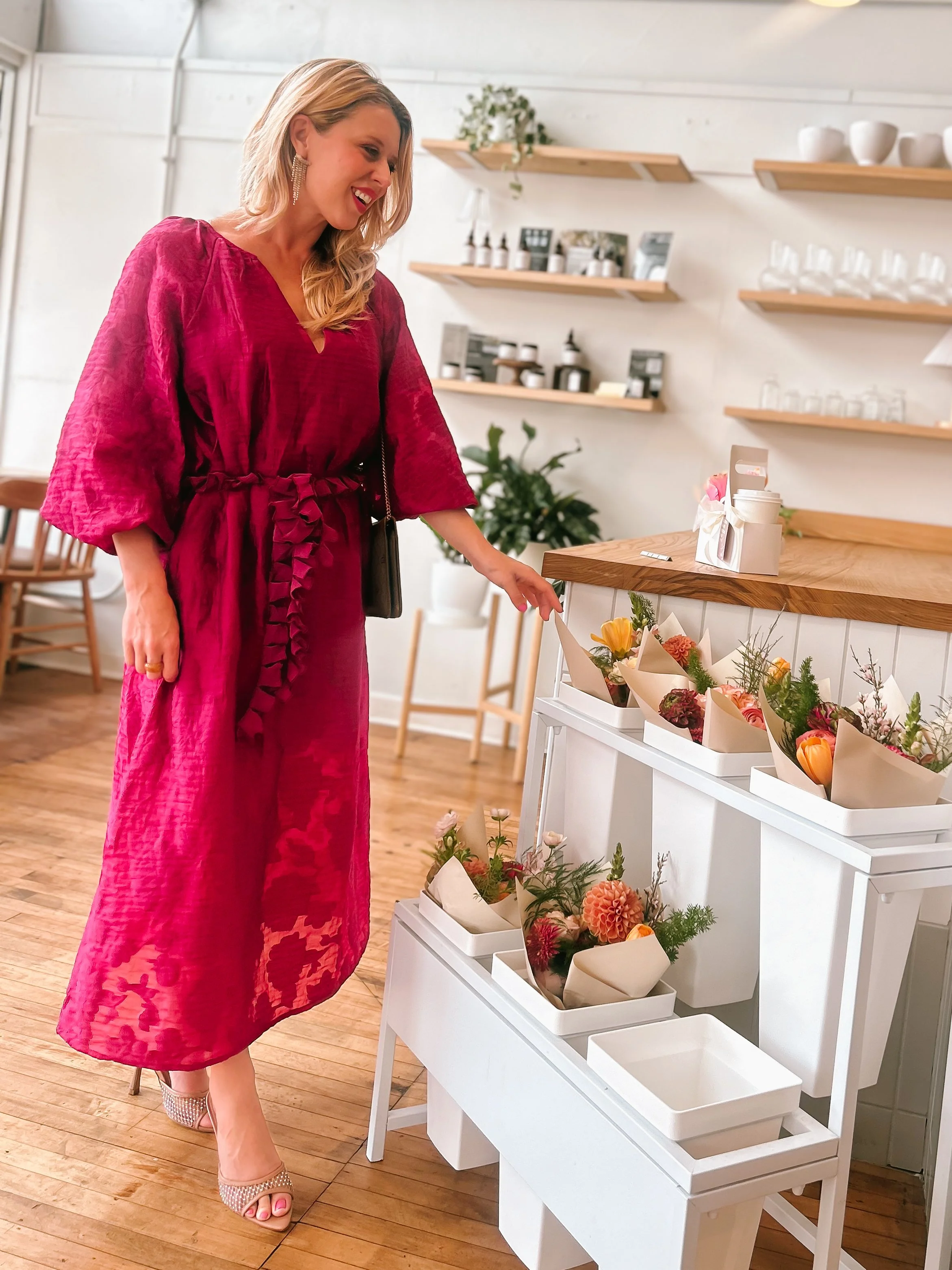 Girl in Pink Dress in Coffee Shop Looking at Flower Bouquet