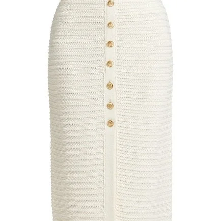 Close-up of a cream-colored, ribbed, button-down skirt with a front slit.
