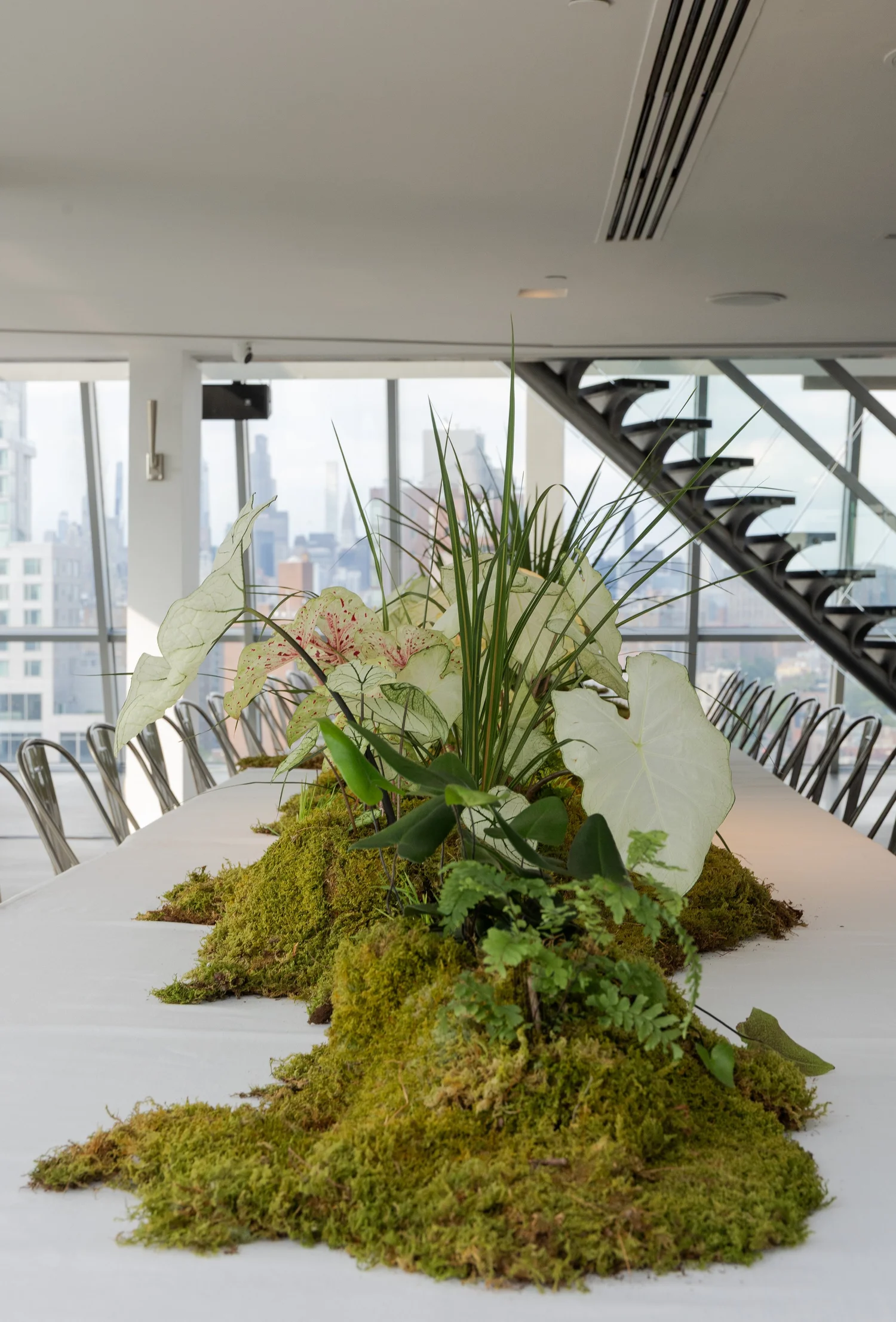 Plant-filled table at Millie Brown's PhotoSymphony dinner in New York, May 2025.