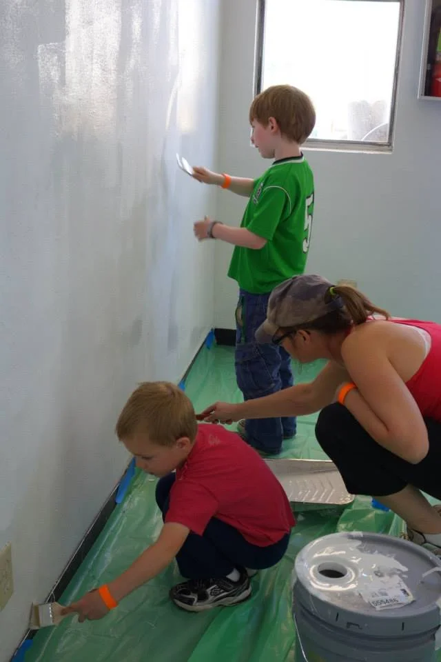 ABQ Involved volunteers and their kids help paint a room at an Albuquerque non-profit agency during UNM's Spring Storm 2013.