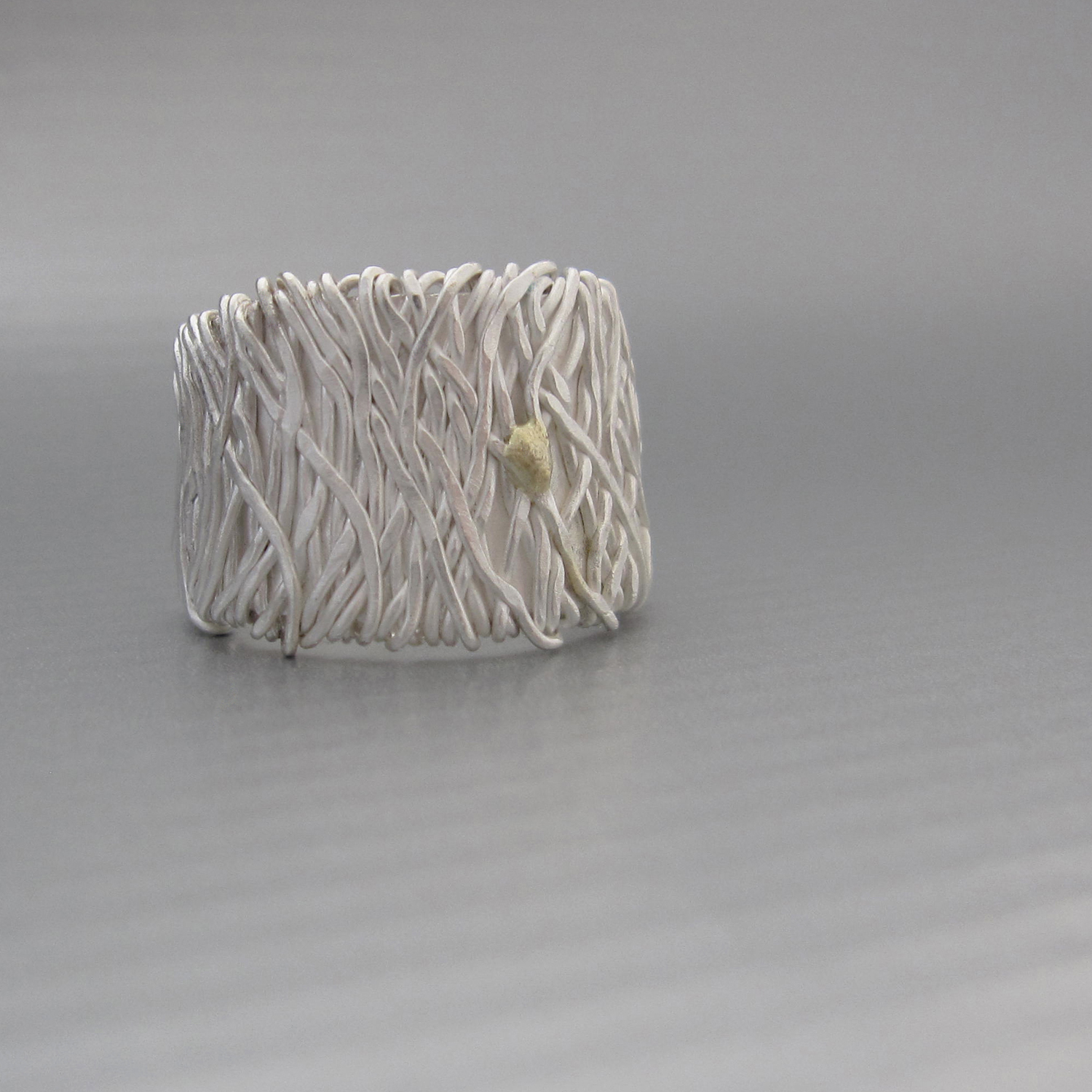 Reclaimed silver and 18k gold blend together to create this unique handmade band