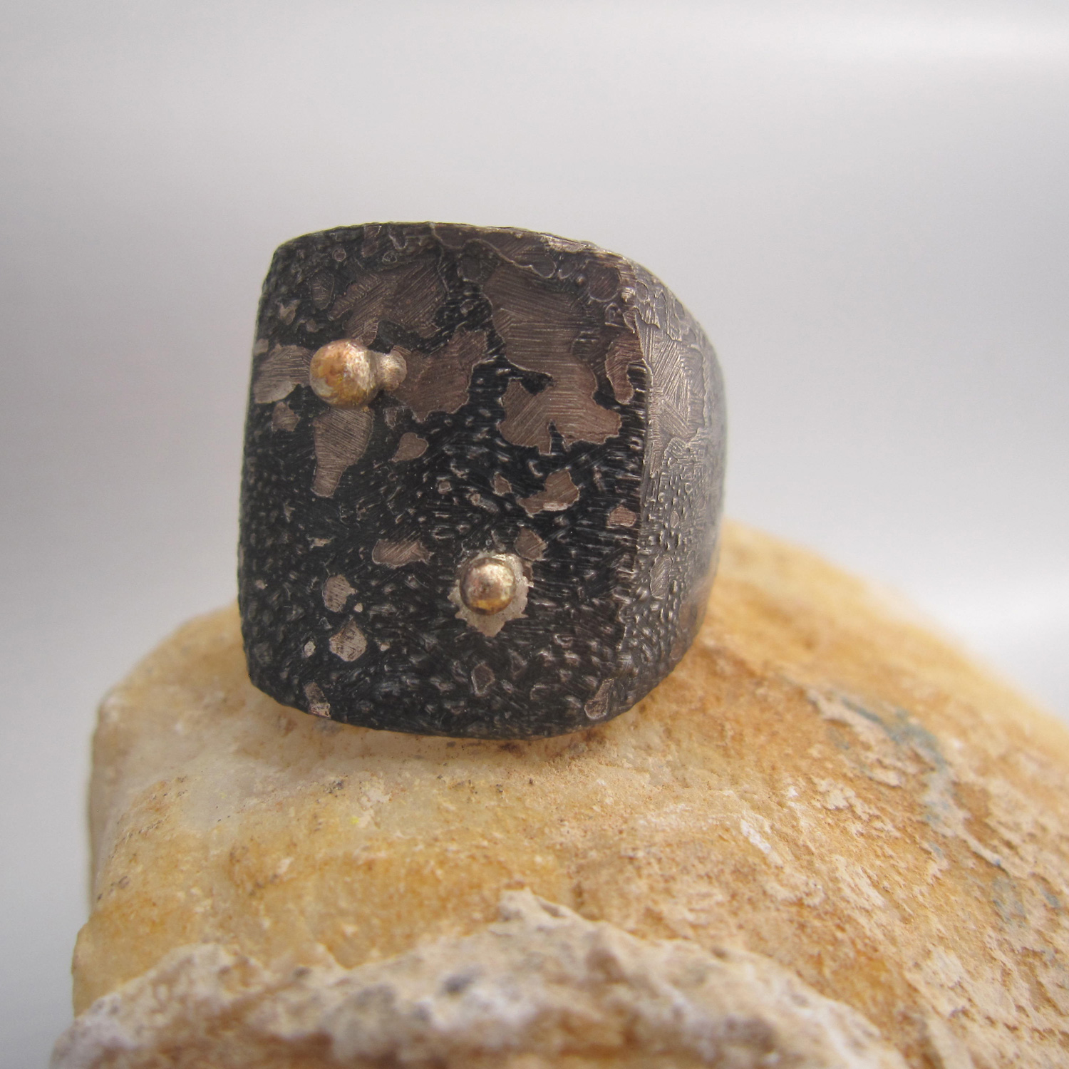 the ring is handmade in reclaimed silver and 14k solid gold