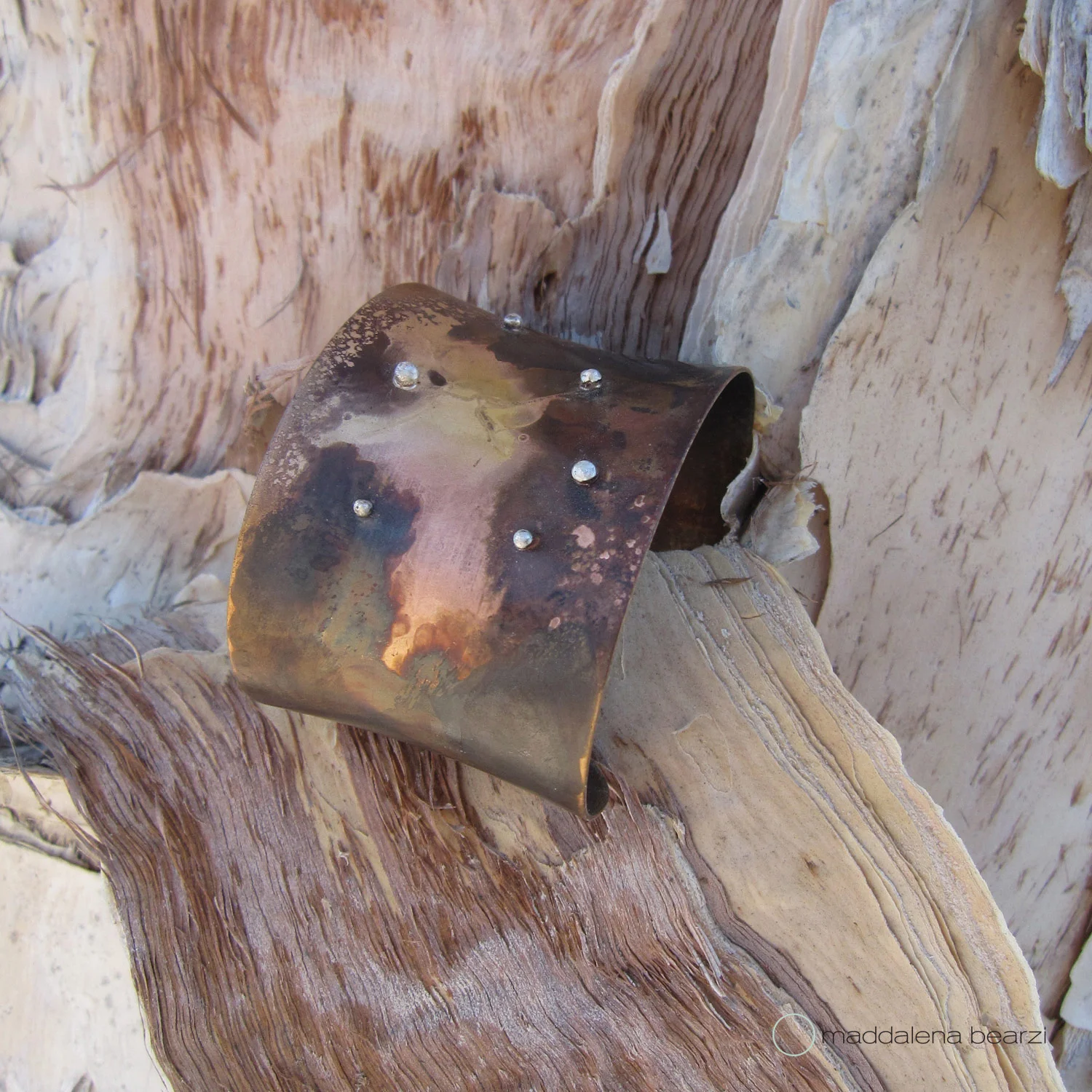 The handmade and one of a kind "terra con sassolini" cuff crafted in brass, copper and silver