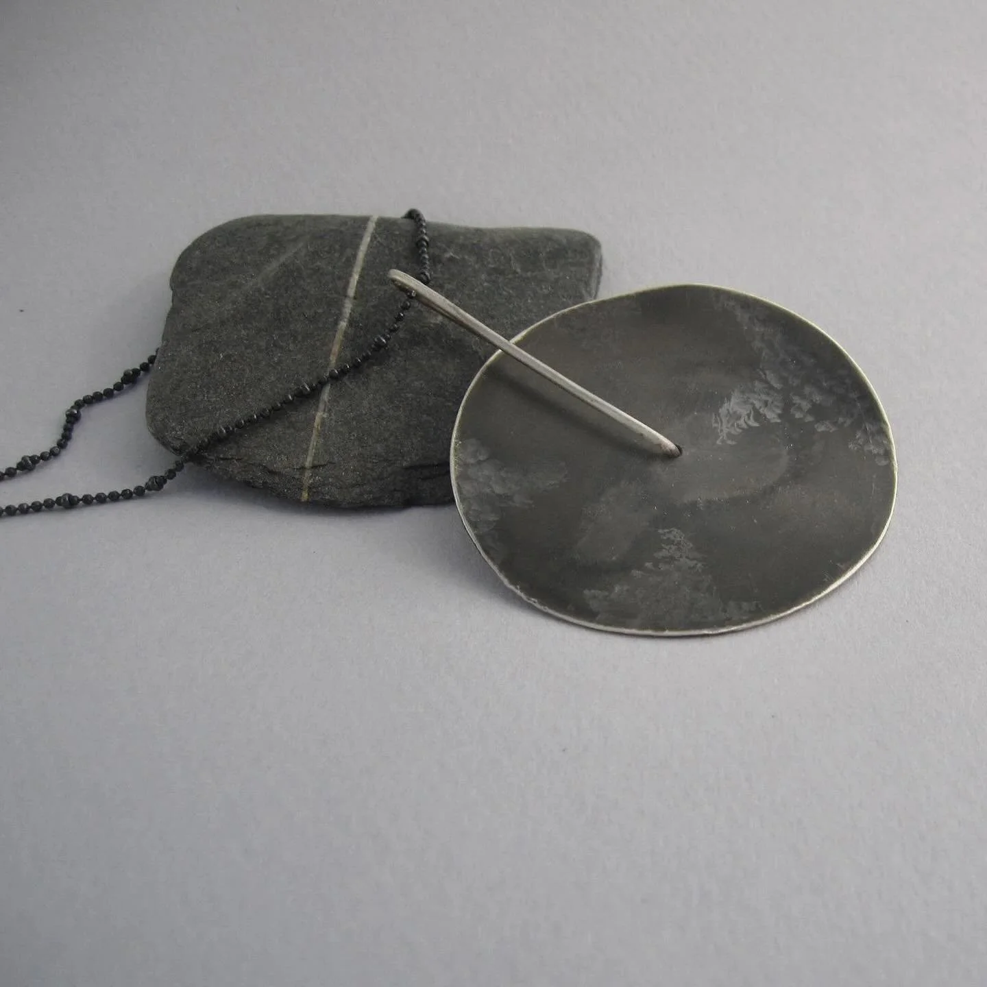 Inspired by the mystery of a dark, textured planet, this one of a kind, bold sterling‑silver necklace is all about presence. Hand‑sculpted with a raw, tactile surface, it creates a striking statement that instantly stands out.
Available here: https:/