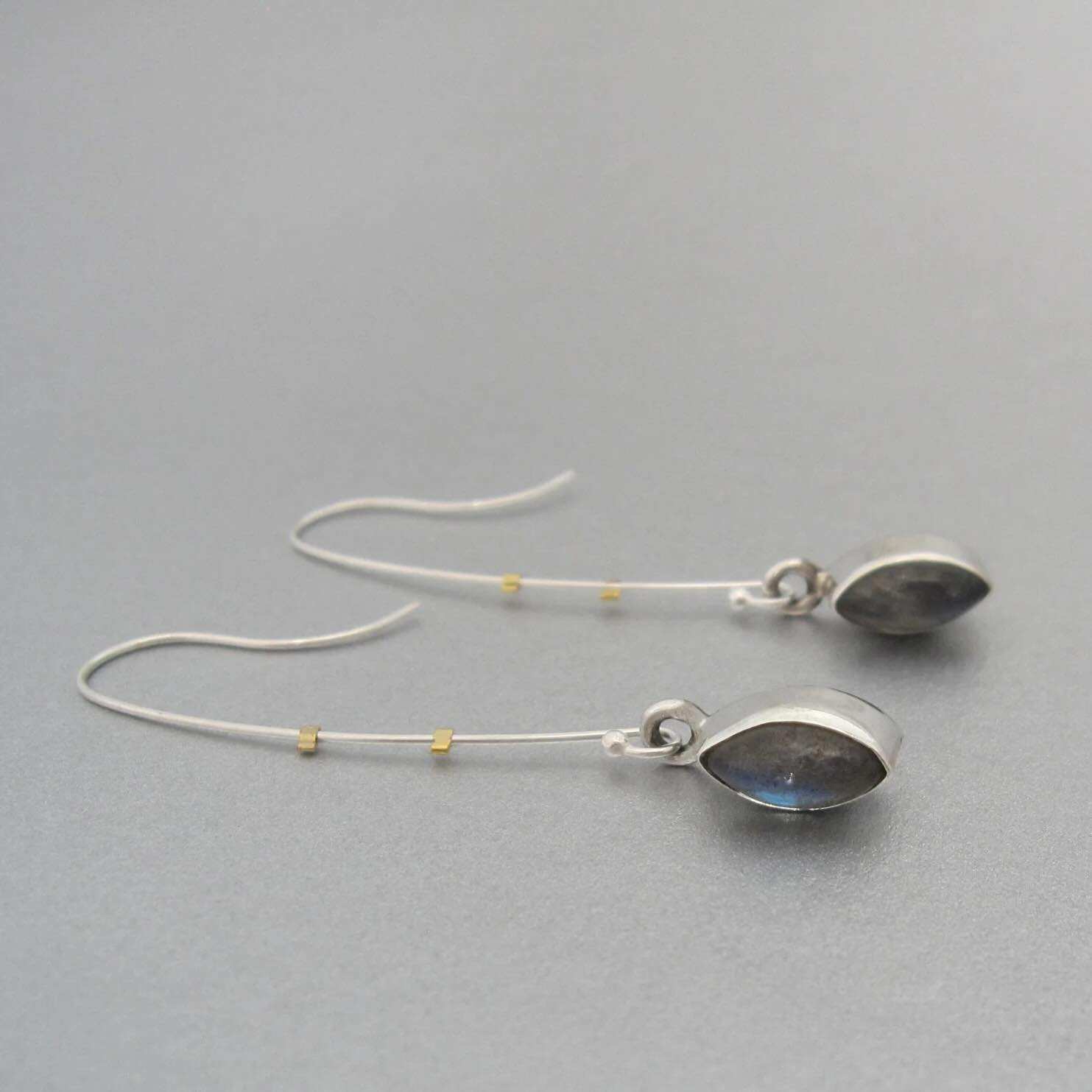 Drops of labradorite with blue and brown tones marry silver and gold in this elegant pair of earrings available in our online shop.

Image+design: &copy;️maddalenabearzi
