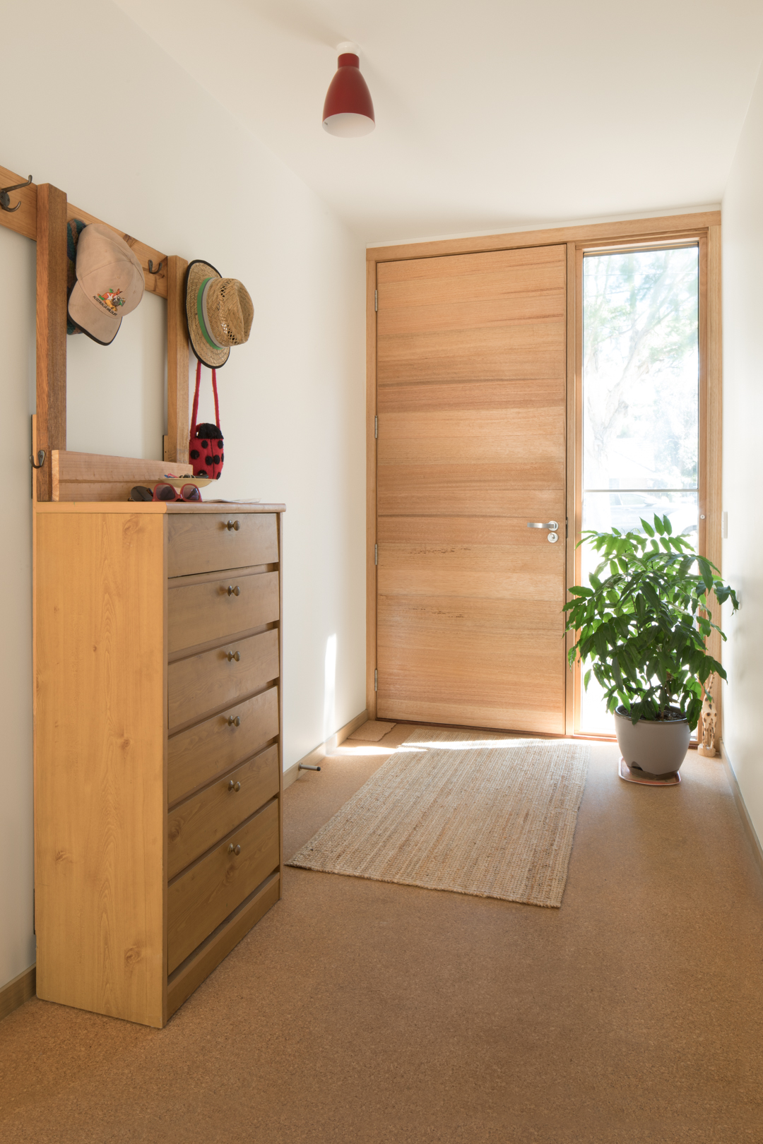  Entry Hall with Australian Hardwood feature front door, cork flooring and sashless double glazed side light window for ventilation.     Photography by Charlie Kinross 