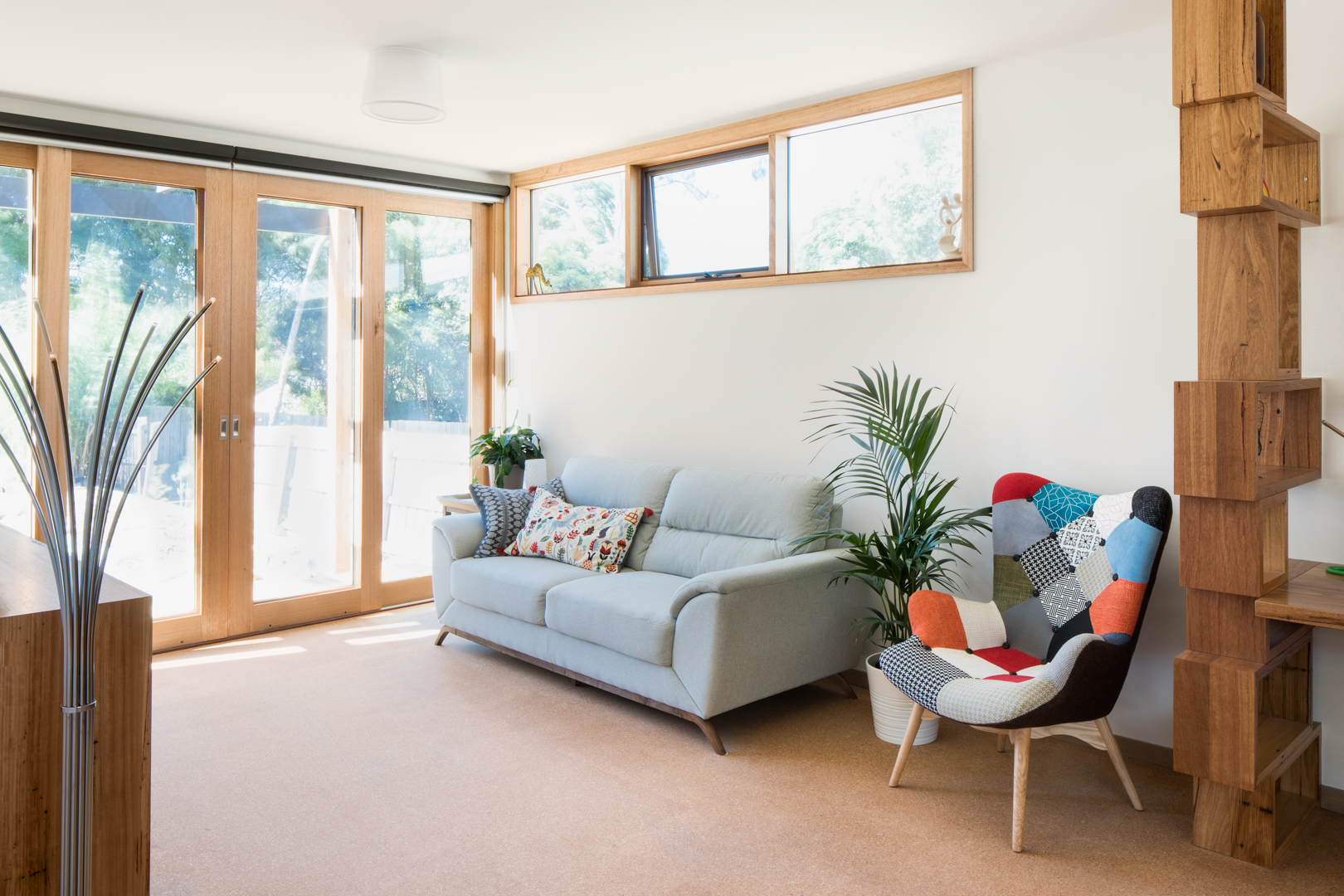  Rear Living Room with recycled hardwood shelving, and Australian Hardwood double glazed windows and doors.  Photography by Charlie Kinross 