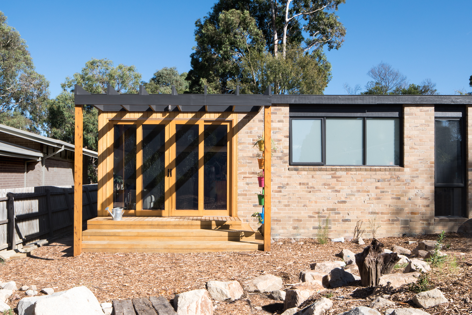  Rear extension with Vic Ash feature shiplap cladding, Vic Ash decking, Cypress feature posts, Australian Hardwood double glazed windows and doors.  Photography by Charlie Kinross 