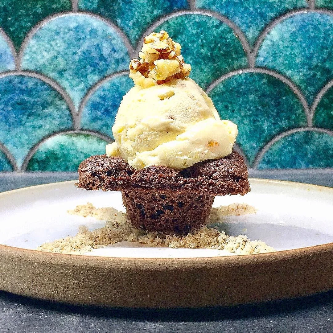 Brownie bowl filled with homemade vanilla and six-pepper jelly roasted nuts and sea salt ice cream topped with nuts and served on a bed of nut crumbs @SmyGoodness