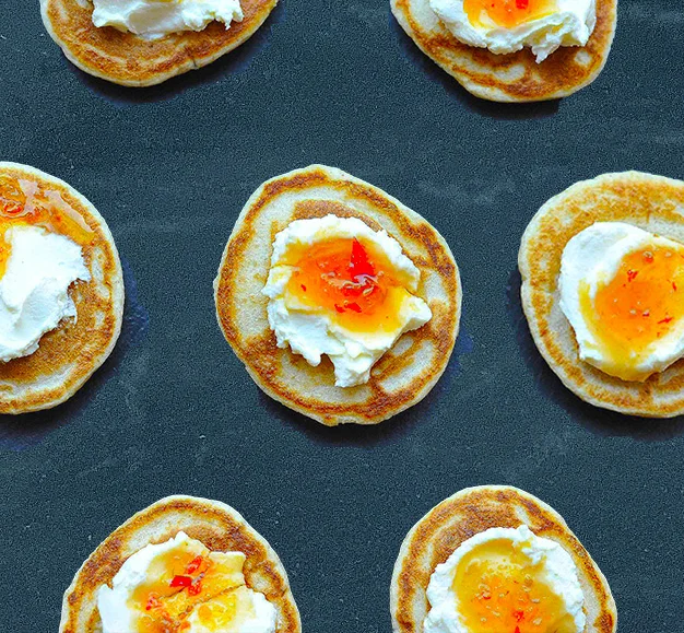 Homemade buckwheat blini topped with cream cheese and Smy Goodness six-pepper jelly. The cream of the cheese pairs perfectly with the heat of the chilli jam.