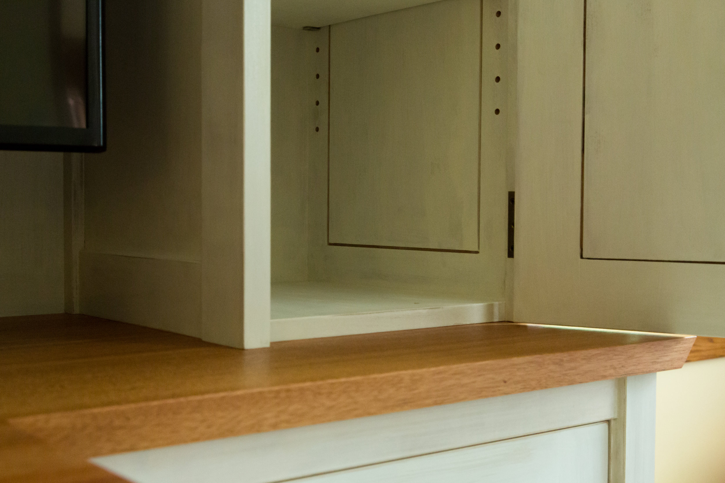 Adjustable shelf detail; back-beveled corner on mahogany counter