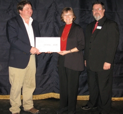 Playwright W. Jeff Bishop accepting the commission from Caroline Abbey and Dave Dorrell.