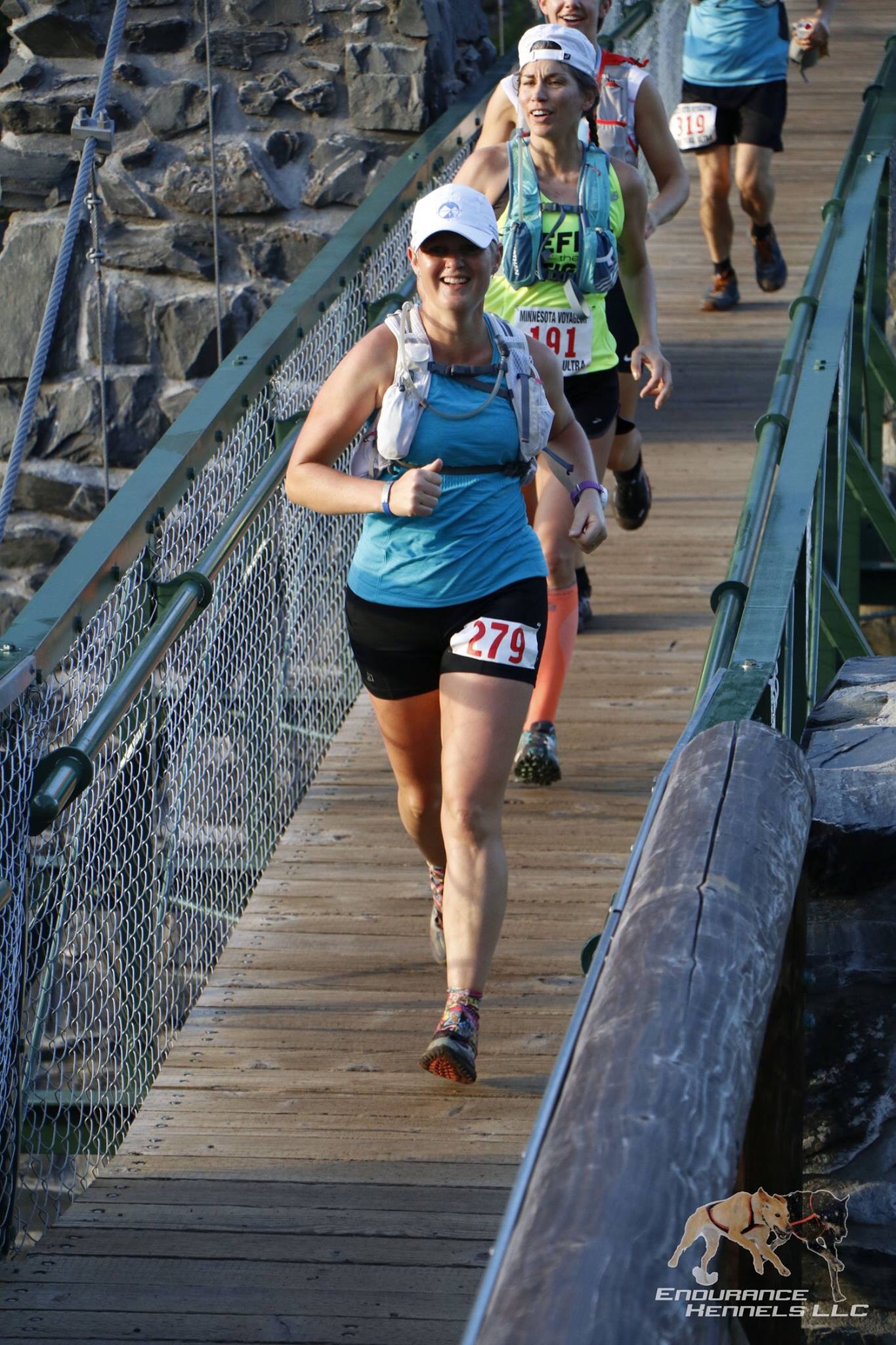 Crossing the swinging bridge 3+ miles in. Endurance Kennels photo.