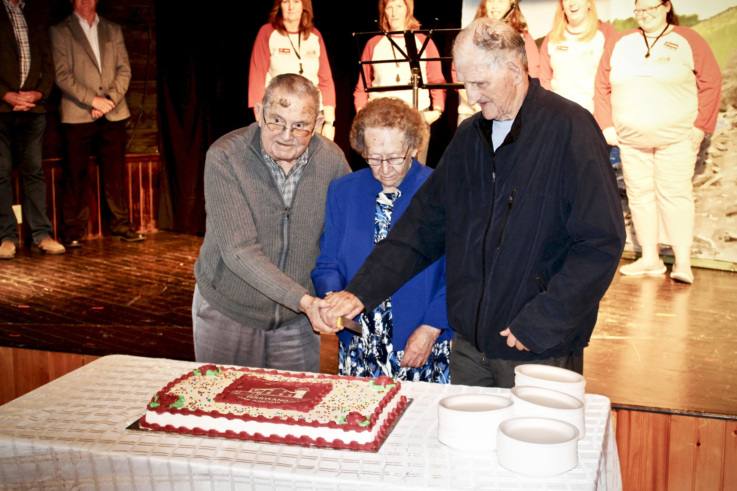  From left to right, Doug Windsor, Joan Costello and Phil Paul, Ferryland’s three eldest residents, cut the Come Home year cake during the Opening Ceremonies. Nathan Ryan Photography 