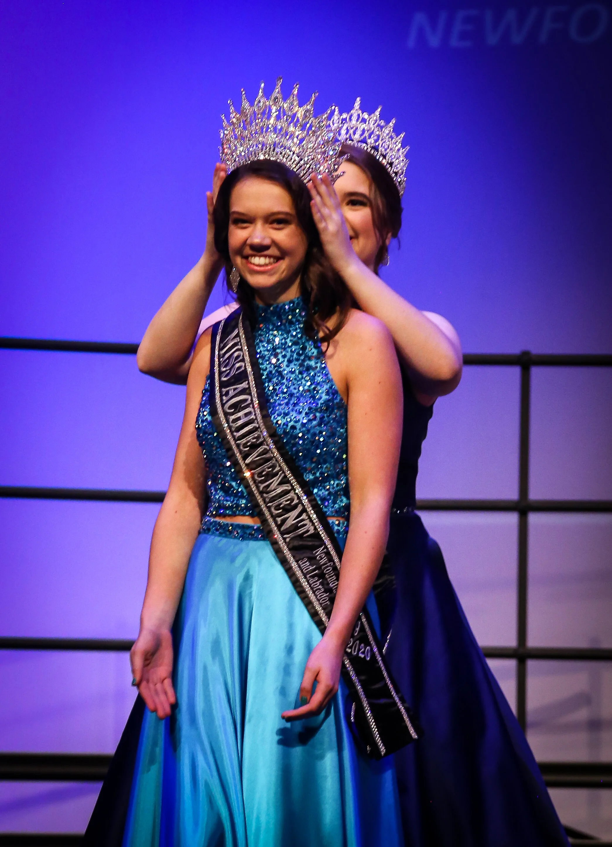  Kathleen Murphy, 17, of Tor’s Cove is crowned Miss. Achievement Newfoundland and Labrador 2019-2020 by Lillith Kelly of St. John’s, last year’s Miss Achievement. Photo courtesy of Ben J. King Photography. 