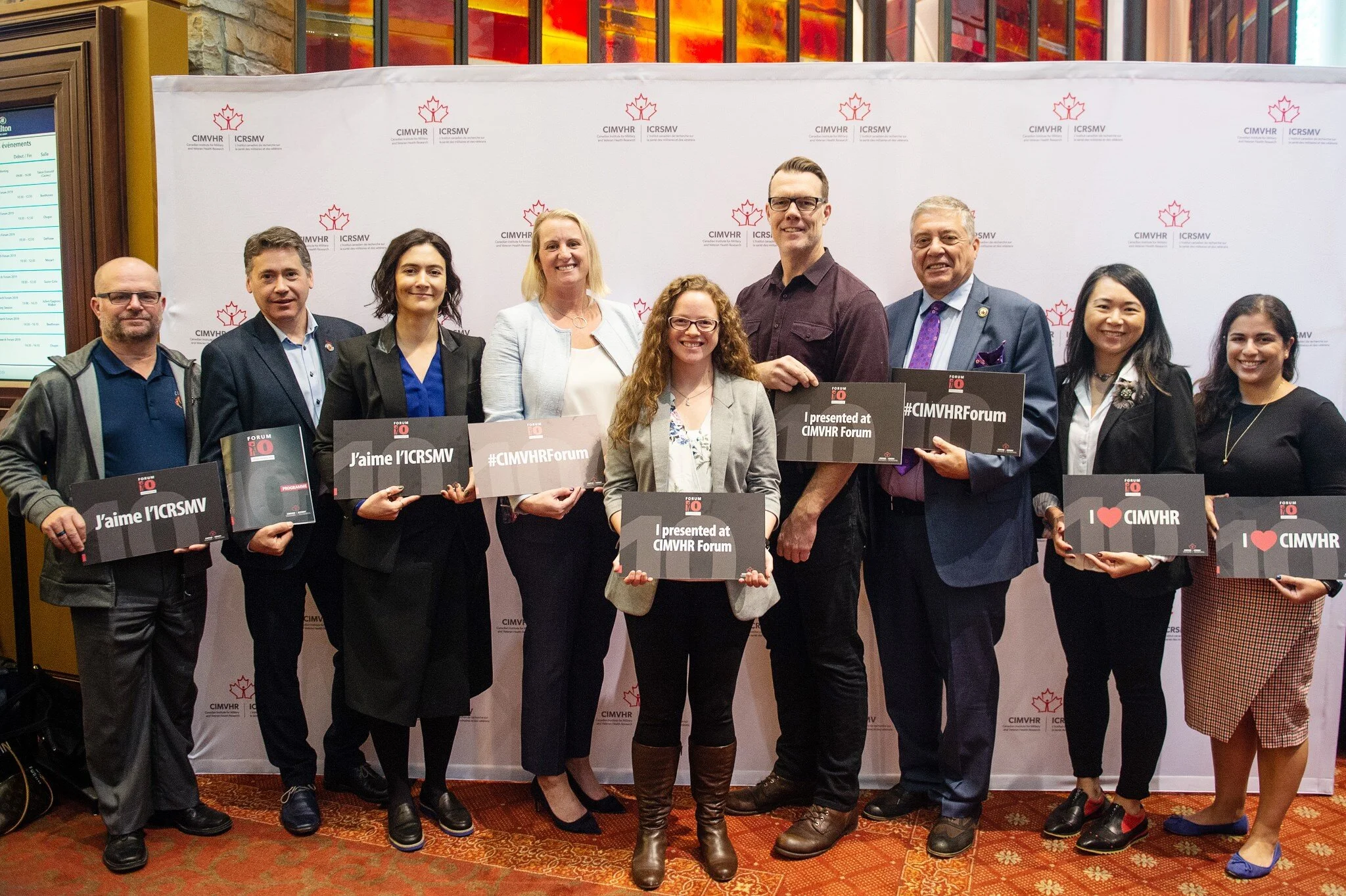  Ashley Williams, centre, at a recent conference where she presented her research on health care for Canadian Forces members who leave the service. From left to right are Lieutenant Colonel (Ret'd) Chris Linford, Dr. Duncan Shields, Dr. Milena Spasojevic, Dr. Megan McElhera, Ashley Williams, Dr. Tim Black, Captain (Ret'd) Phil Ralph, Dr. Linna Tam-Seto, and Dr. Celina Shirazipour. 