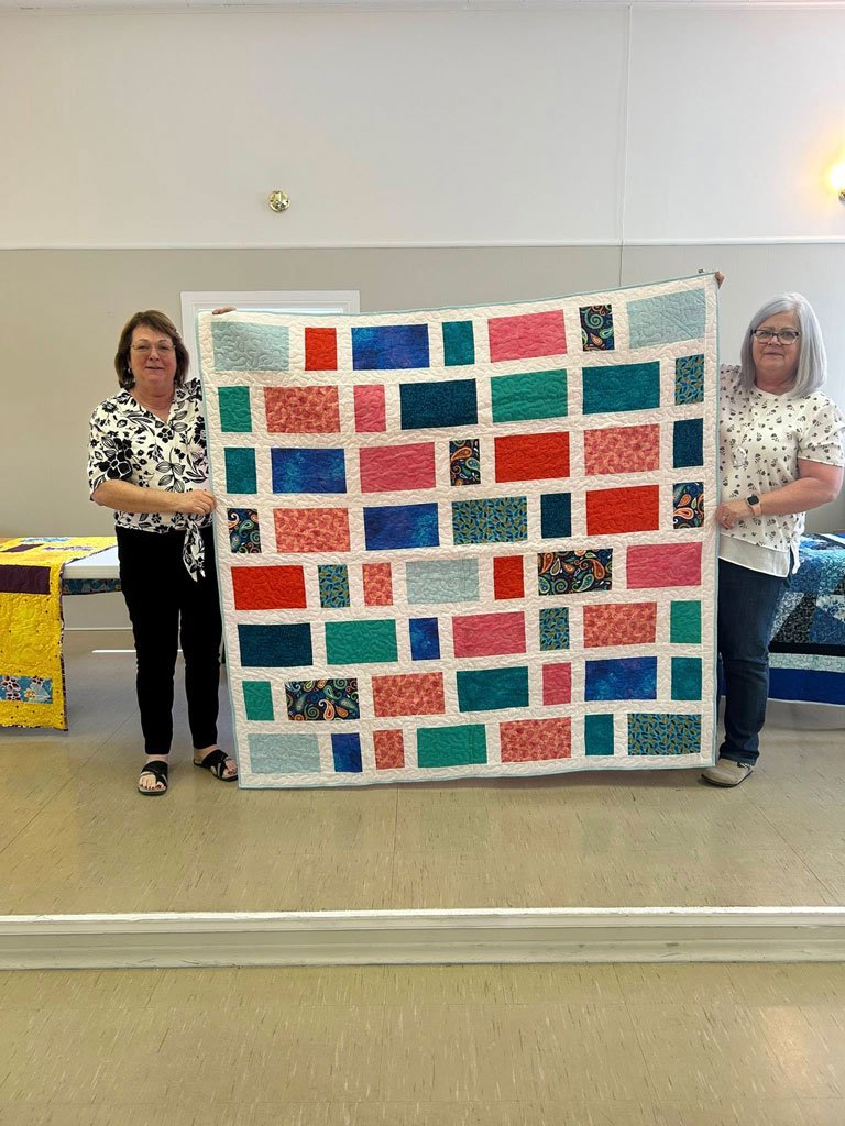  One of three handmade quilts donated by the members of the St. Joseph’s Monday Quilting Group. Displaying the quilt are Lorraine Murphy, left, and Rose Driver Jones. Submitted photo 