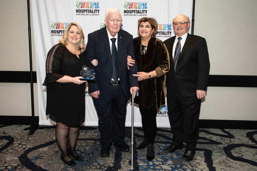  A man well known for his sense of hospitality received a special recognition award from Hospitality Newfoundland and Labrador last month, during the group’s annual general meeting and awards gala. Pat Ryan, second from left, was accorded HNL’s Tourism Excellence Employee Award. With, Mr. Pat, as he is known, were, from left, Kelly Finlay, who manages The Wilds where Ryan works, federal cabinet representative Gudie Hutchings, and the resort’s co-owner, Glen Roebothan. 
