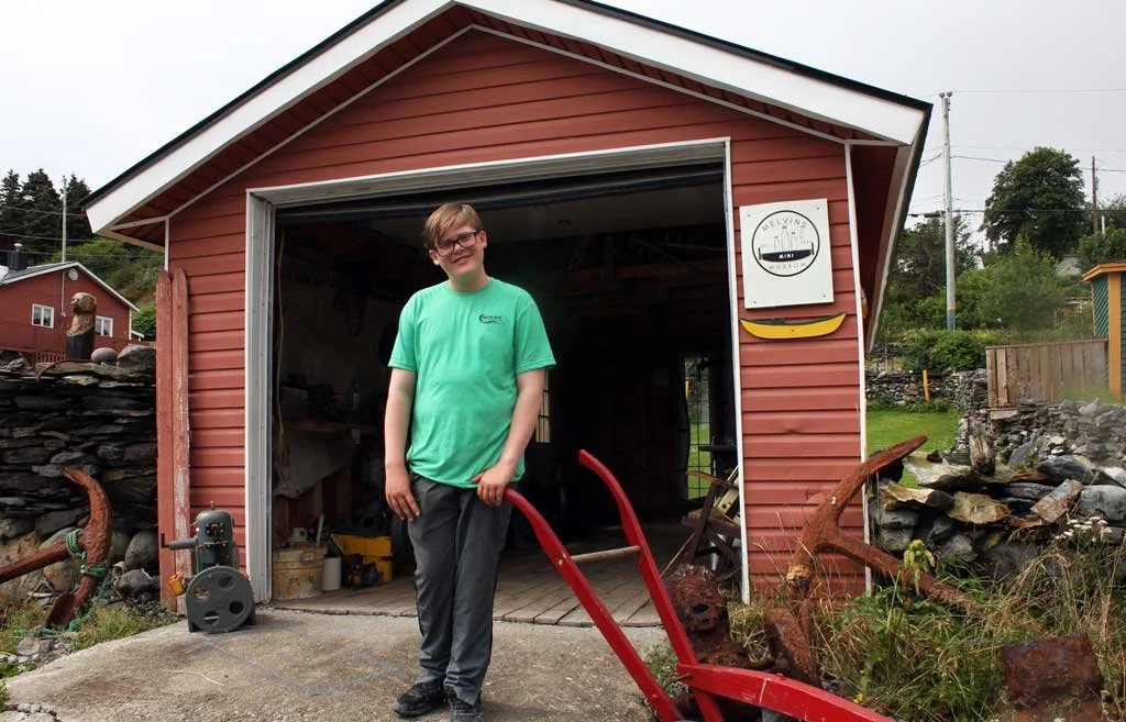  Fourteen-year-old Jaden Melvin outside Melvin’s Mini Museum in Bauline East. The museum is now open for it’s second season. Submitted photo 