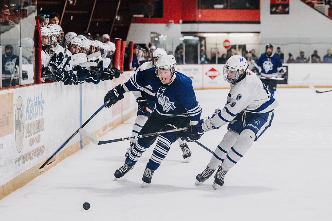  St. Kevins High School student Brendan Ryan tries to steal the puck from Alumni player Mark Williams who tries to protect it during action in the annual Charity Classic at Goulds Arena earlier this month.  Bringing up the rear is St. Kevin’s High School student Keegan O’Brien. Photo courtesy of Stacey Birmingham Photography 