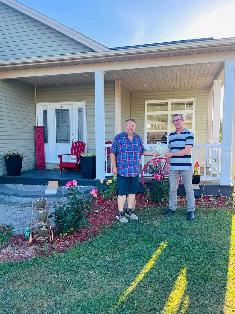  The Town of Bay Bulls has announced the winners of the annual Golden Tulips Awards. Pictured is Mayor Keith O’ Driscoll (right) presenting Mark Traverse the 2024 Golden Tulip Award for Best Beginner Garden. Traverse was accepting the award on behalf of his wife Kelly, who has the greener thumb of the two. Mary and Armand Williams were awarded the 2024 Golden Tulip Award for Best Vegetable Garden. The 2024 Golden Tulip Award for Best Overall Residential Property went to Greeley’s Garden. Aimee Greeley nominated the garden in honor of her late husband, musician Justin Greeley, who passed following a short but courageous battle against cancer. Town of Bay Bulls photo 