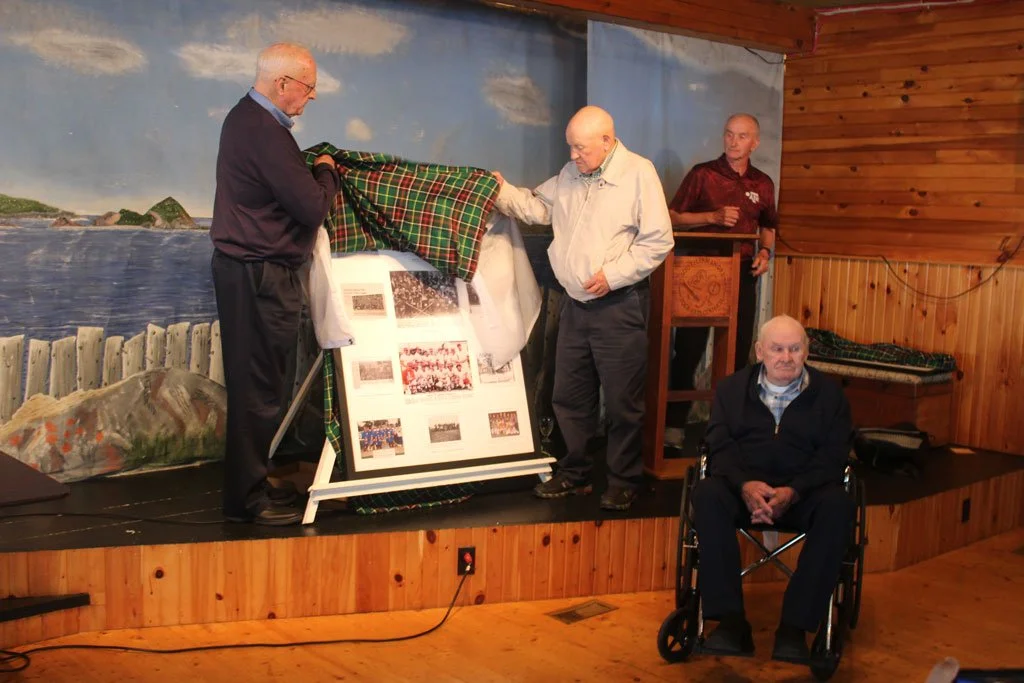  Because Ferryland has such a rich sports history, the organizers of a commemorative board that was unveiled at the Regional Arts Centre last week had to limit the photos in it to just ones where championship trophies were on display. Helping to unveil the shadow box were, from left: Ron White, Cyril Walsh, John Kavanagh and, in the foreground, Gerald Hynes. Mark Squibb photo 