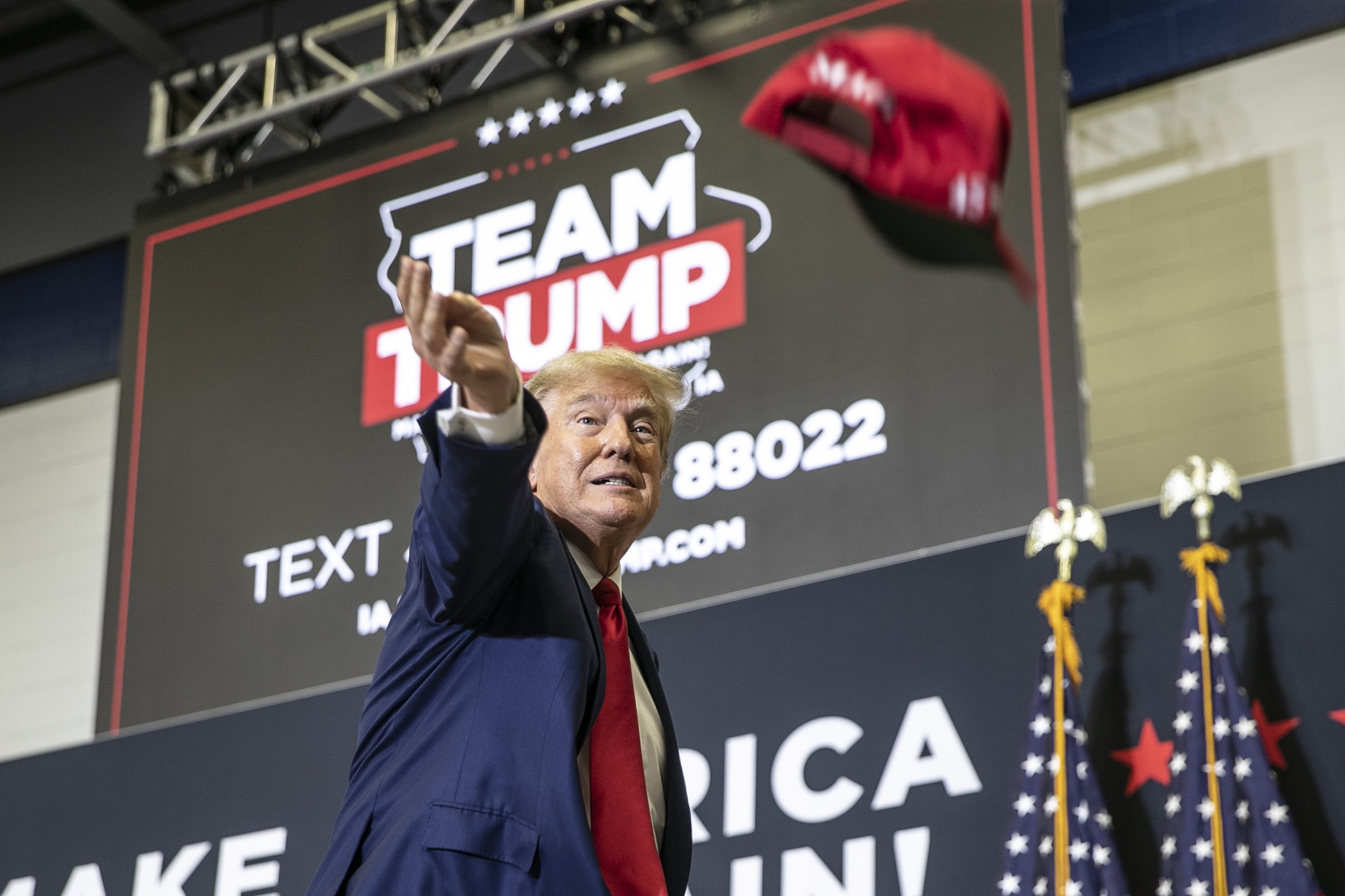  Republican presidential candidate and former President Donald Trump tosses out hats to the crowd during a caucus event on Saturday, Dec. 2, 2023, at Kirkwood Community College in Cedar Rapids, Iowa. The event drew a crowd of several hundred attendee