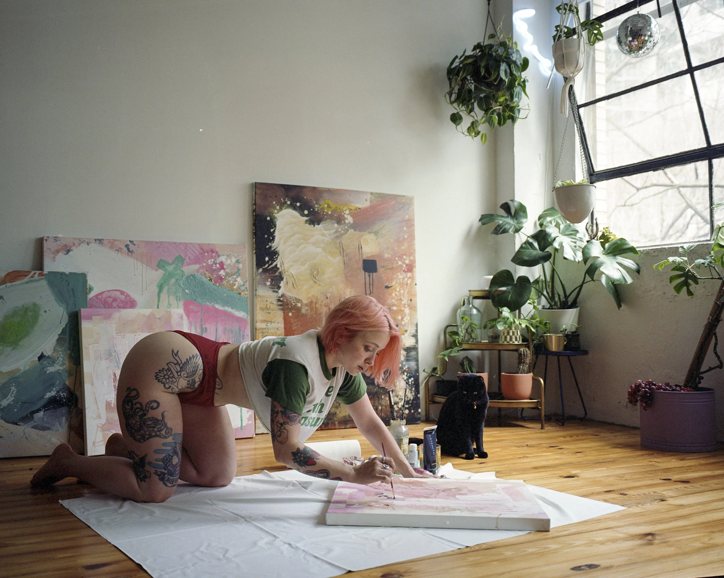 Christian paints on canvas in her loft. Photographed by Quintavius Oliver, Atlanta Portraint Photographer. Mamiya 7II + 43mm f/4.5 + Cinestill 400D