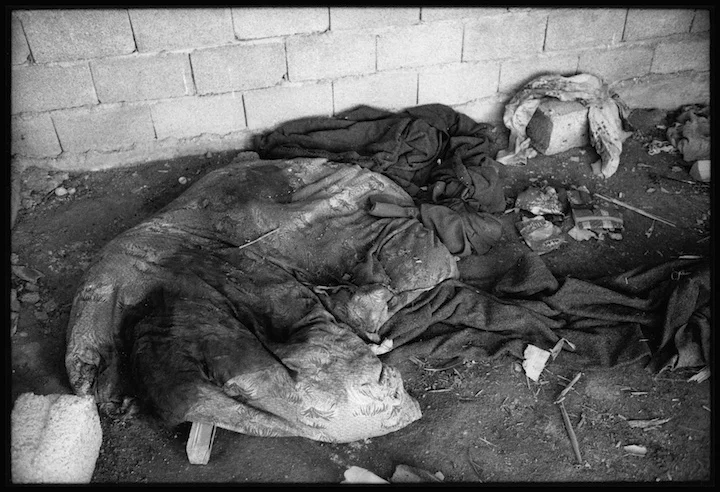 I was taken to this roadside shack by some Kosovo Liberation Army soldiers who were trying to locate a mass grave for me. Outside the shack were the torso and legs of a girl. The girl had been raped inside the shack. There was a significant amount of blood in the area of her genitals and a meat hook suspended from the ceiling. Their was blood stained bedding on the floor. In the area next to the body was evidence of a fire and canned food where someone had enjoyed lunch. Many refugees reported that young women were dragged from vehicles and raped by the side of the road by Serb military and paramilitary forces. 