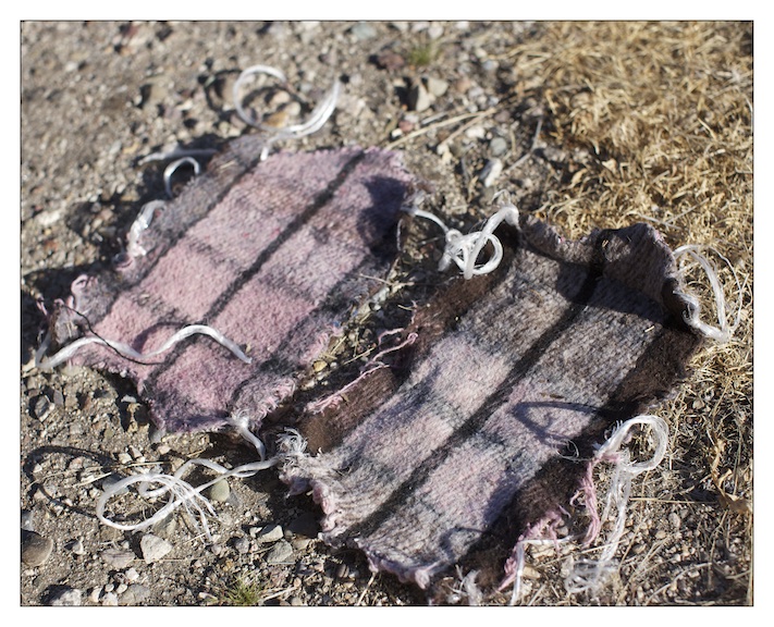  A pair of shoe covers made from a blanket used by migrants to mask their footprints on the trail. 