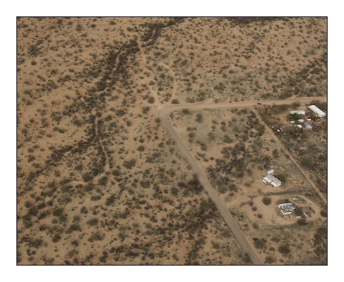  The bend in the road at the centre of this photograph is at Diamond Bells Ranch near Robles Junction. Diamond Bells was built as a restful and upscale desert retreat before the recent property market crash. In 2010, unbeknownst to the owner of the h