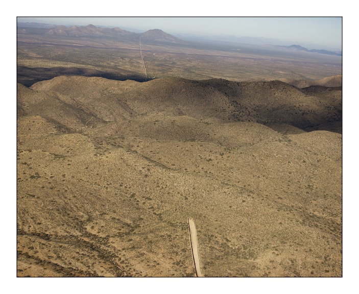  The border fence between Mexico (on the left) and the United States (on the right) stops abruptly as the Baboquivari Mountains rise out of the desert near the hard scrabble town of Sassabe that straddles the border in southern Arizona. The fence cos