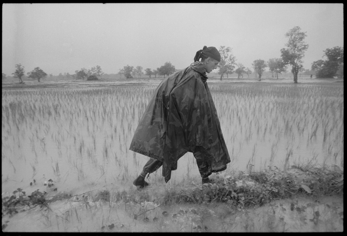  Philip on patrol with the KPNLF during the rainy season in Cambodia. 1990 