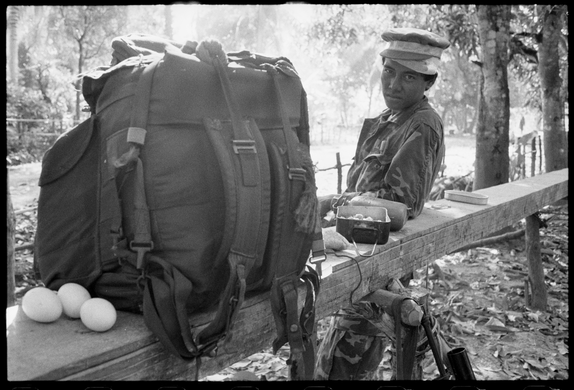  KPNLF soldier with 2 hats and 3 eggs. Cambodia, 1991 