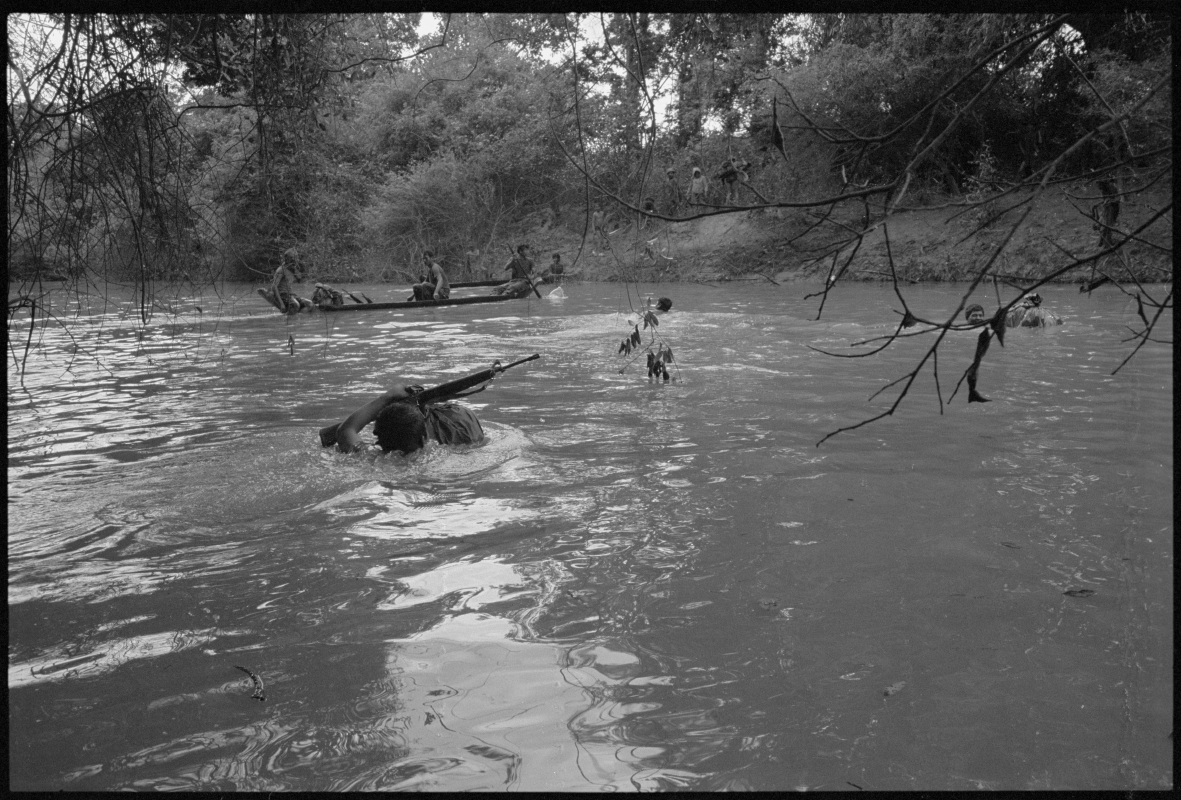  KPNLF soldiers cross a swollen river during a long range 6 week mission, Cambodia,&nbsp;1991 