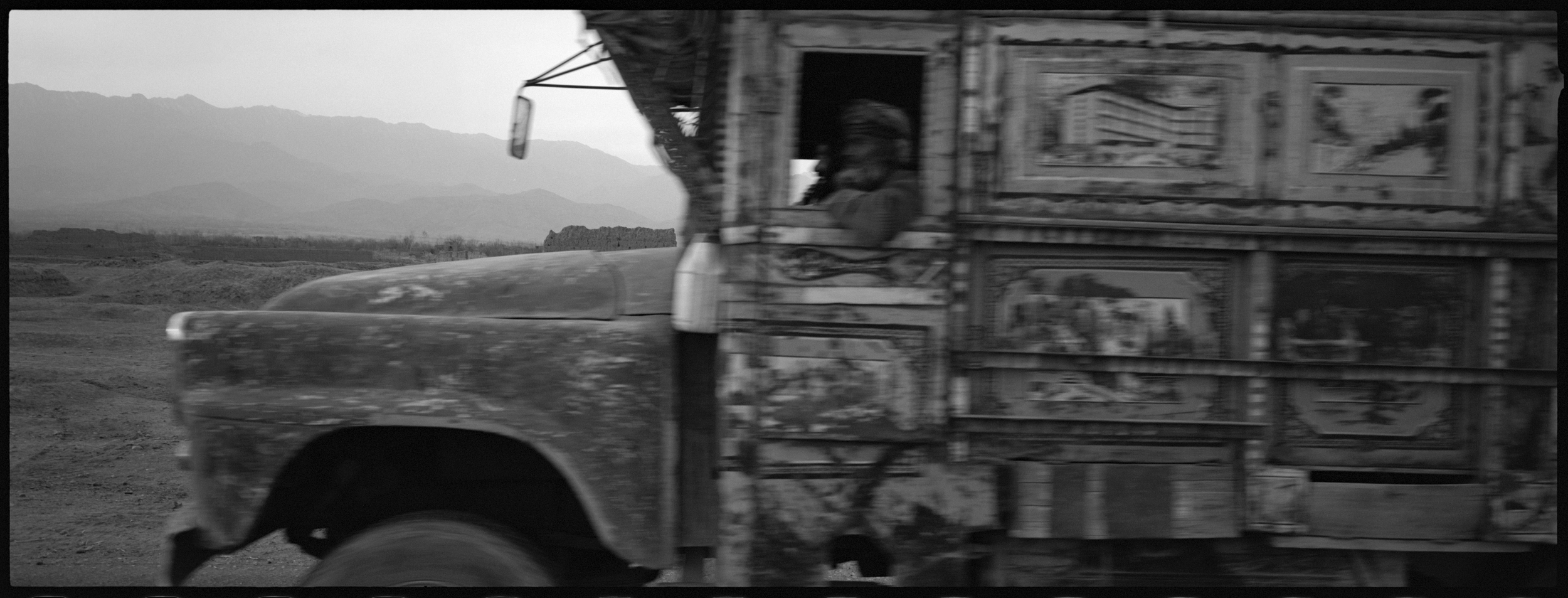  An old truck races north on the Old Road from Kabul to the Panjshir Valley through a heavily landmined area.

 