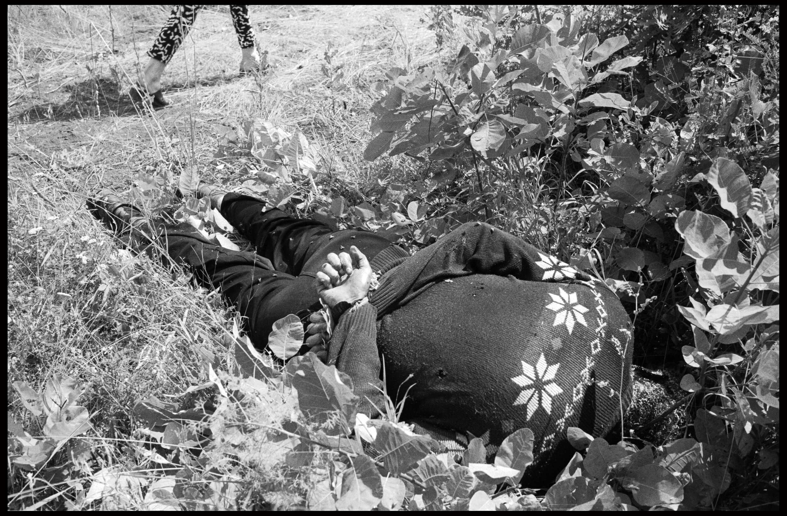  This and the following three photographs show the bodies of two men executed in a vineyard in the village of Xrce. The naked man carefully folded his clothes and tucked his socks into his shoes before he was killed. It appears that the killers wante