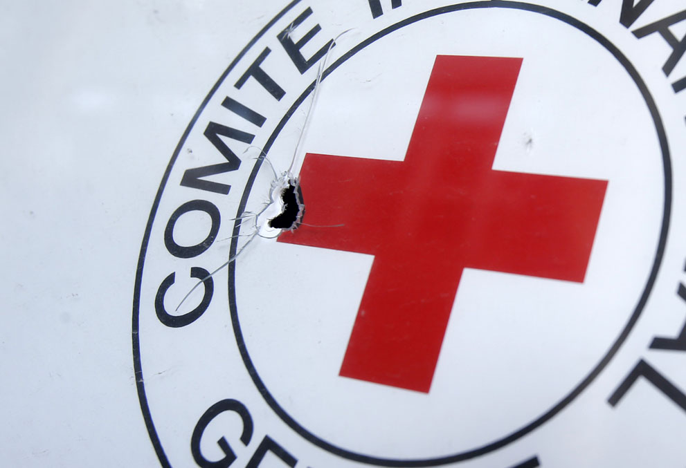 A bullet hole in a Red Cross sign, outside an office in the town of Donetsk on October 3, 2014. A Red Cross staffer died when a shell landed near the group's office in Donetsk. (AP Photo/Darko Vojinovic) Courtesy of The Atlantic