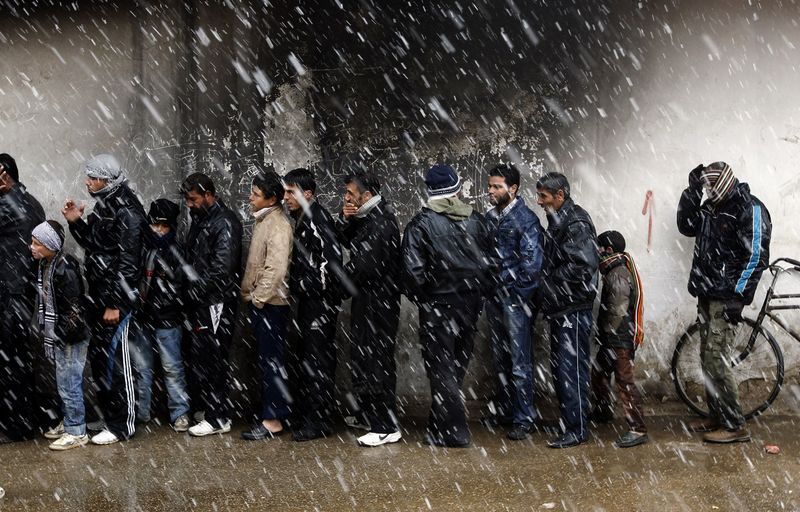 Growing needs outside of Baba Amr - Waiting to buy bread, Al Qusayr, near Homs - Photo courtesy of Reuters/Goran Tomasevic