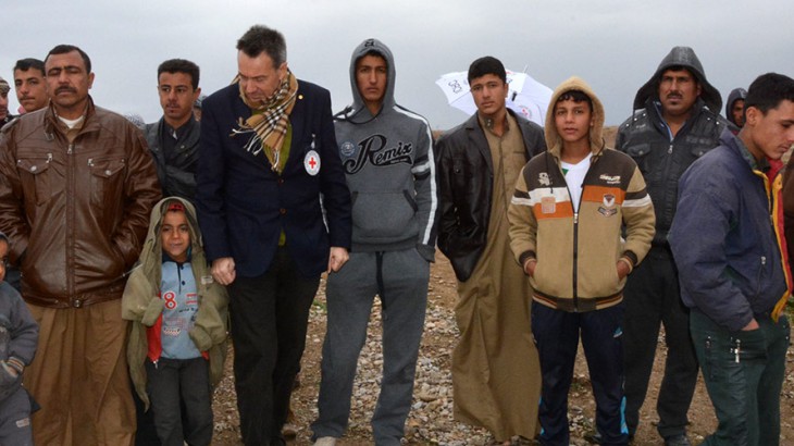 During a January 2015 visit, Mr. Maurer (pictured wearing an ICRC badge) said he heard "heartbreaking stories" from people displaced by fighting in Iraq. Copyright: ICRC / S. Dabbakeh