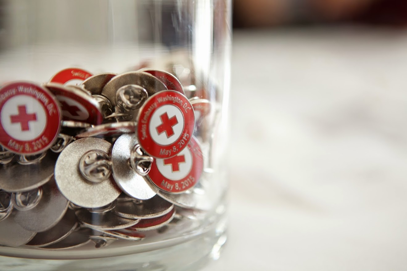 Bucket of ICRC pins on table