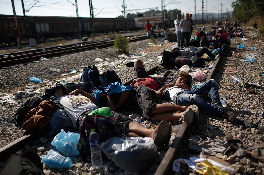 Photo of the Week: FP published a gallery titled "by land or by sea" capturing the journeys that REFUGEES are making to europe to escape their war-torn countries. In this shot, Syrian and Iraqi refugees sleep on railroad tracks in idomeni, Greece, while waiting to be processed across the macedonian border. © win mcnamee. 
